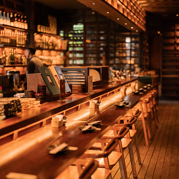 Warm wooden interior of Rayjin Japanese restaurant in Bali